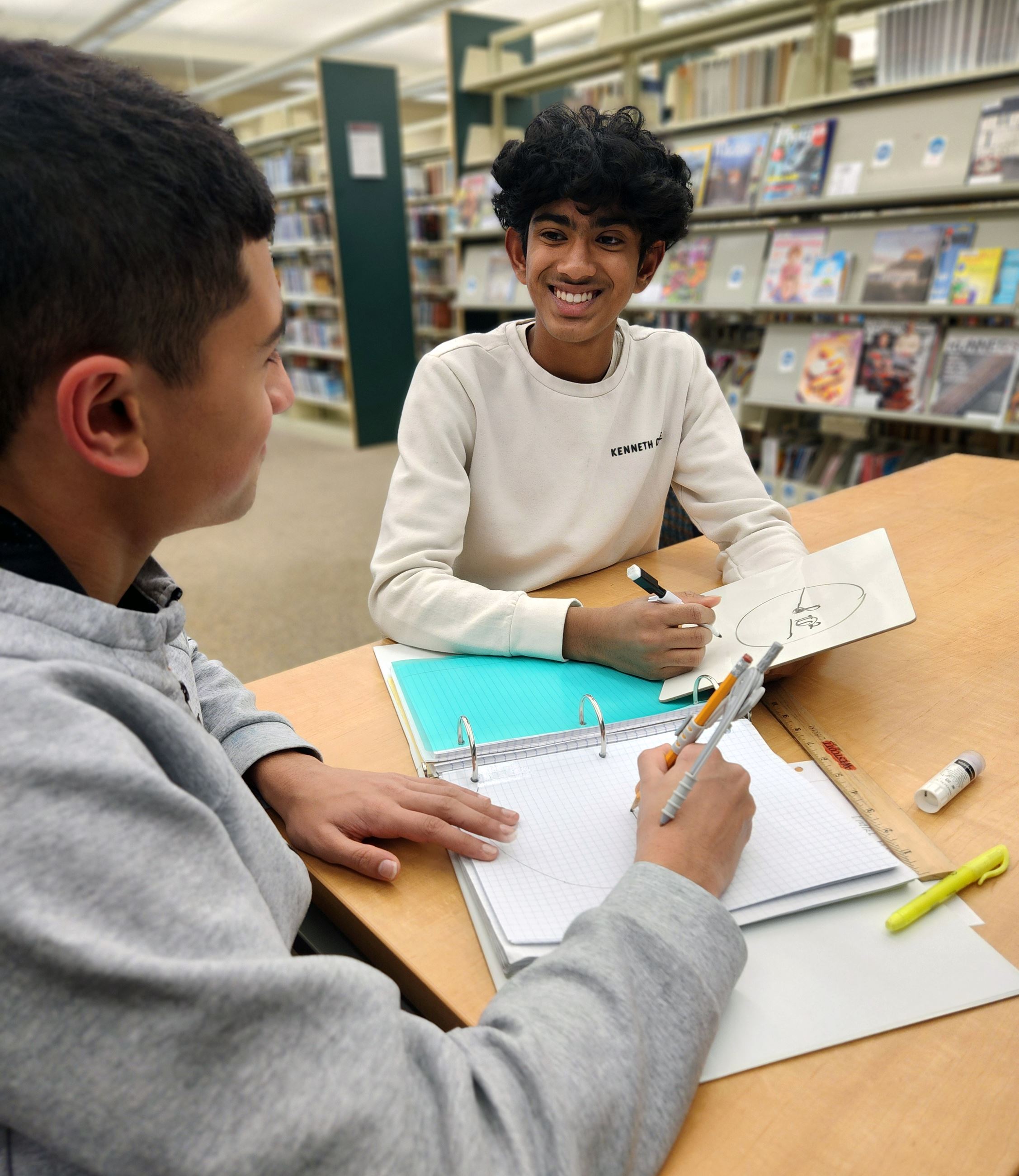 Teens working together on homework at R.H. Stafford Library